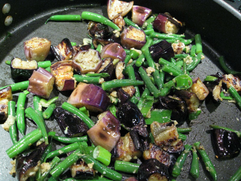 Colors pop and flavors explode when combining green beans, eggplant and the garlic/onion/ginger mixture