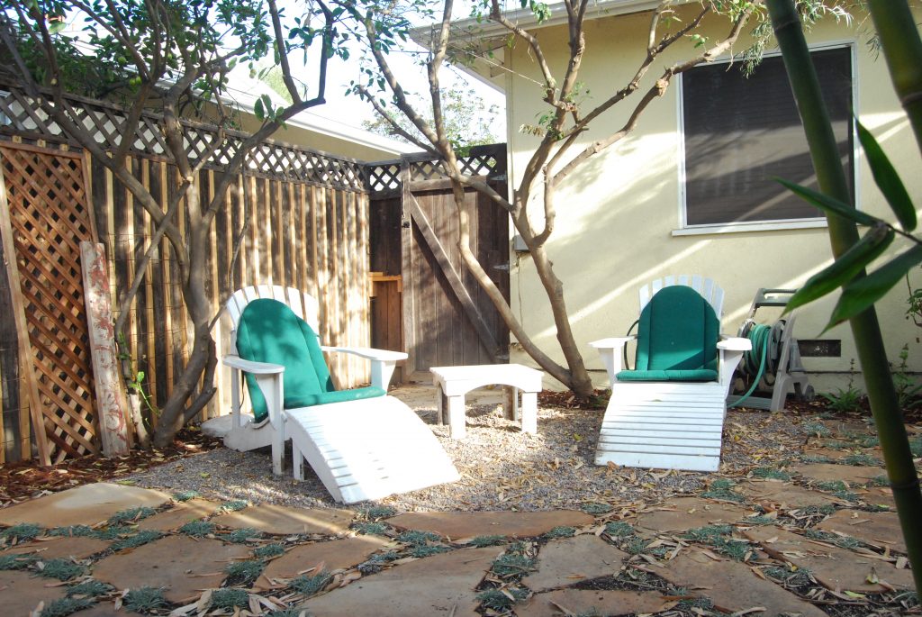 Adirondack chairs needed a home. Now they sit under two citrus trees in their own space. Perfect for reading on a summer day.