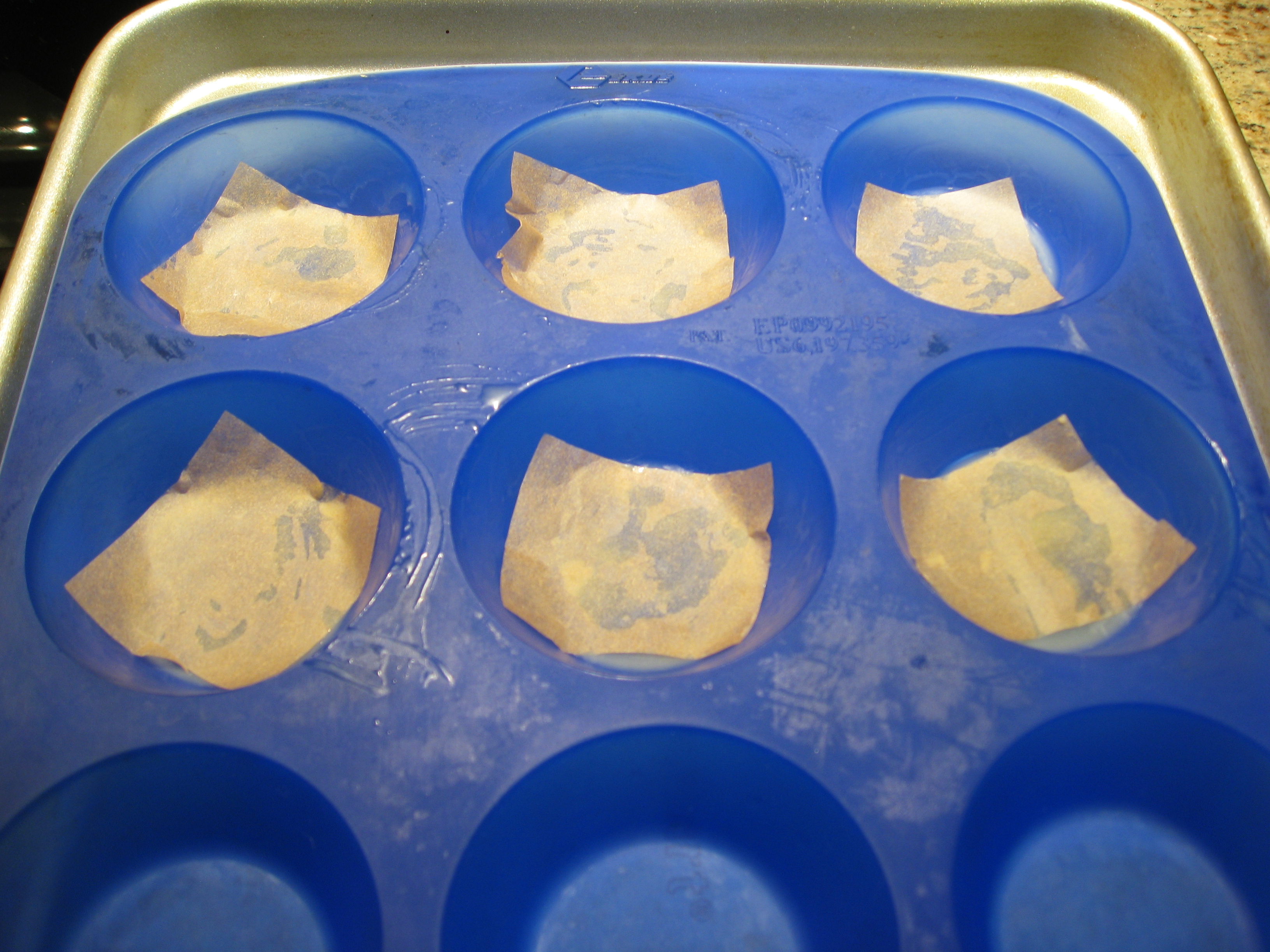 Buttered mini muffin tins, ready to go.