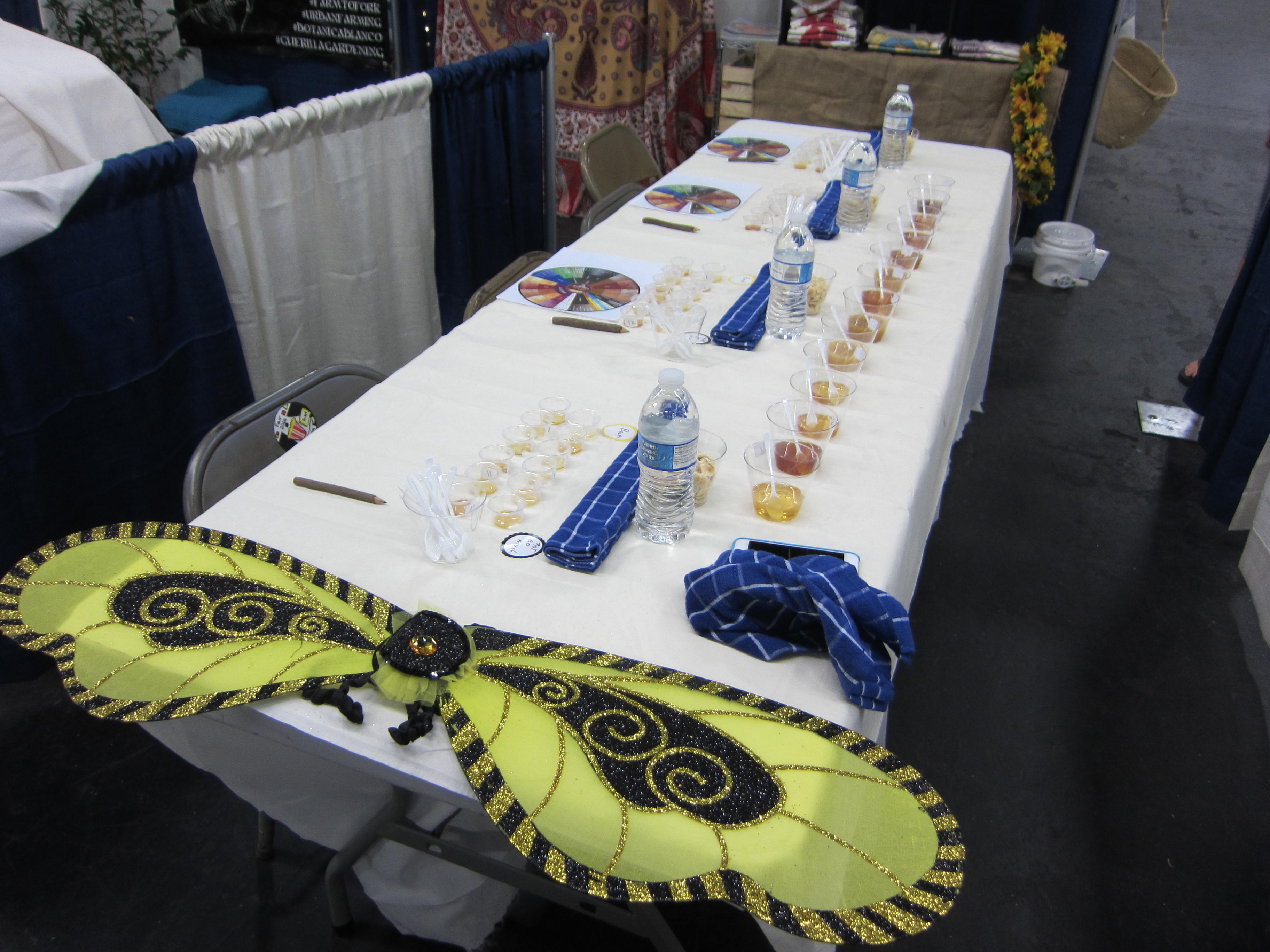 Set up your honey tasting table as a blind taste test. Numbered containers, and a place to write notes. 