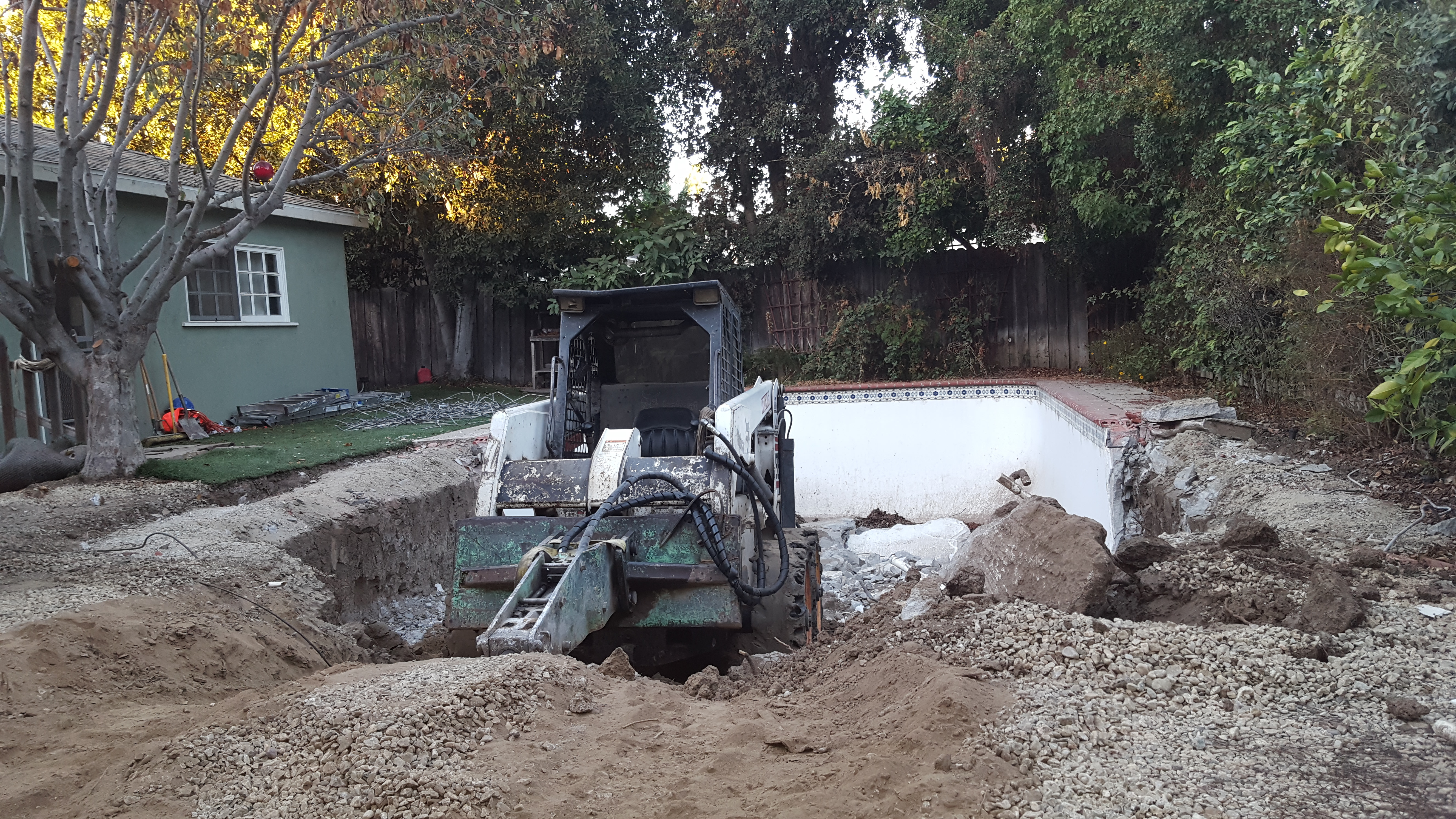 Bulldozer at work demolishing the client's swimming pool.