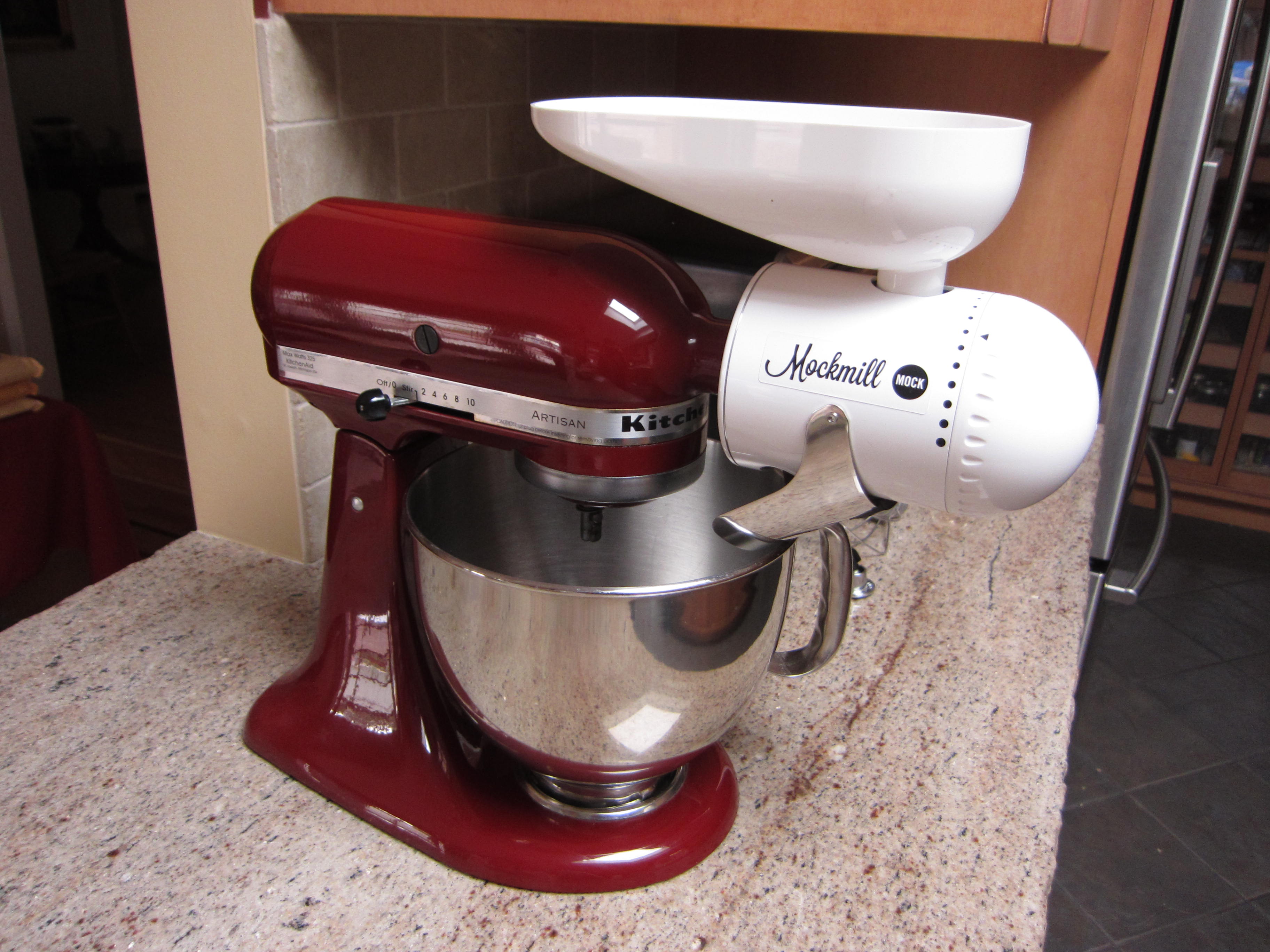 The Mockmill fits easily onto the Kitchenaid mixer and the metal shoot is designed to dump flour straight into the bowl below. 